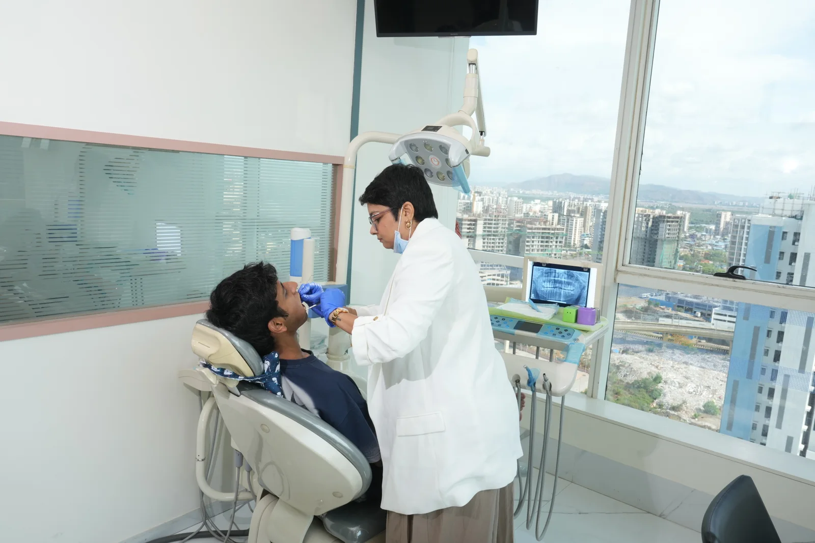 Dr. Urvashi Pithadia treating a patient at Dr. Pithadia's Clinic, Kharghar